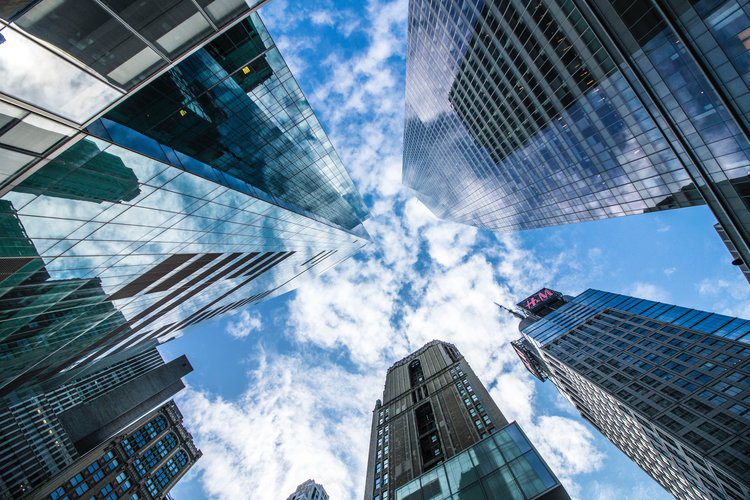 Looking up at sky from city